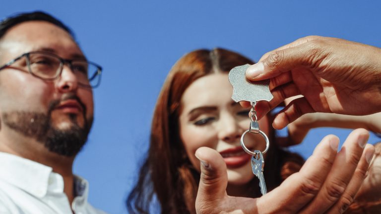 Couple receive house keys outdoors