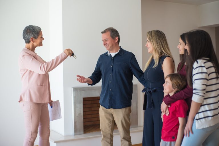 Estate agent gives keys to dad with wife and three children