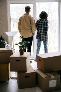 First time buyers looking out of glass door