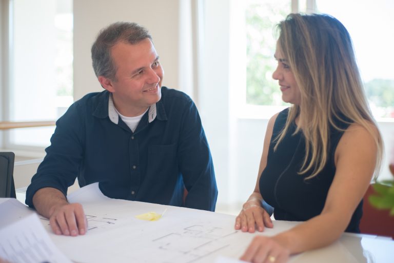 Scullion LAW property lawyer and client smiling over documents