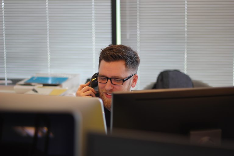 Scullion LAW staff calling clients smiling behind computer screens