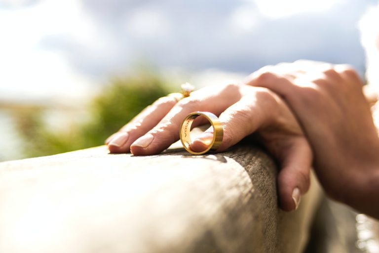 Woman removed gold wedding ring outdoors considering divorce and separation