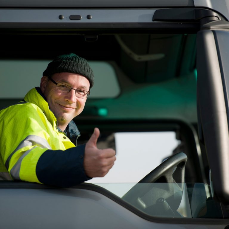 Lorry driver gives thumbs up whilst driving
