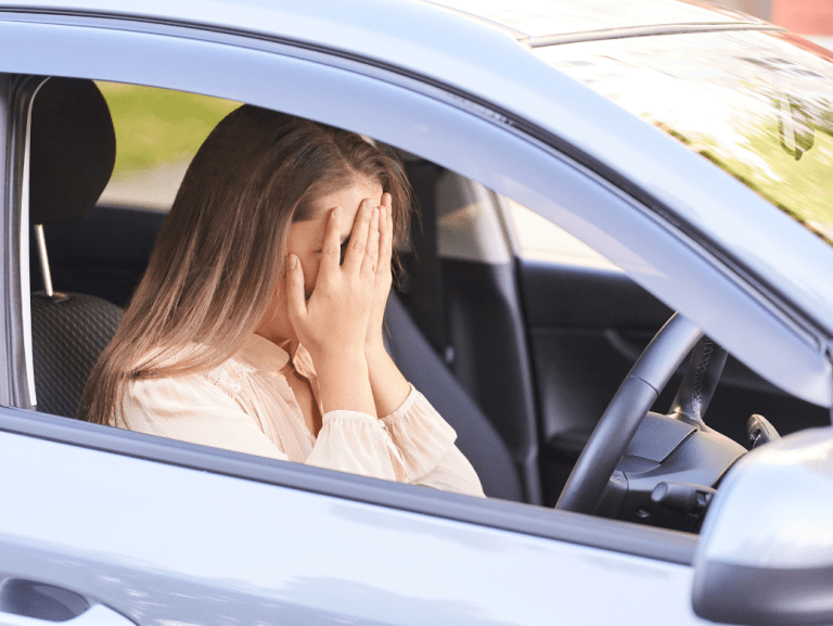 Female driver driving whilst disqualified holds her face in her palms
