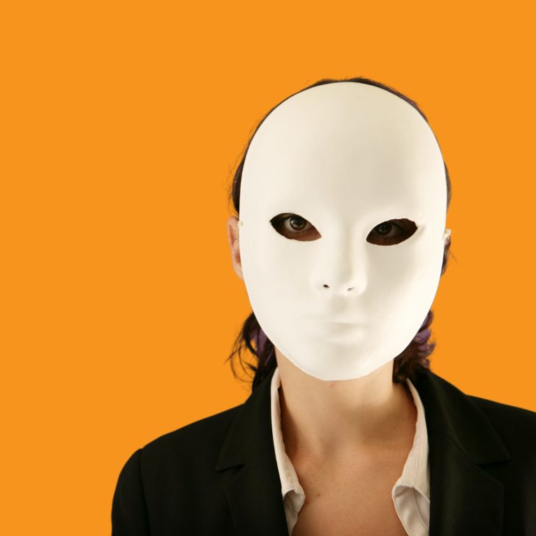 Female on an orange background wearing a white mask