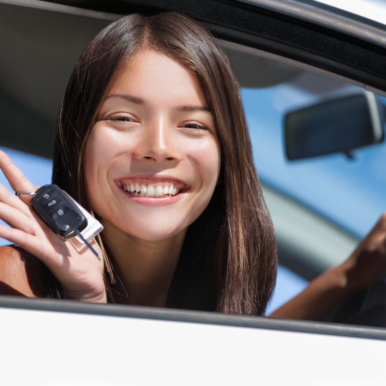 Happy road traffic client smiles with car keys in hand