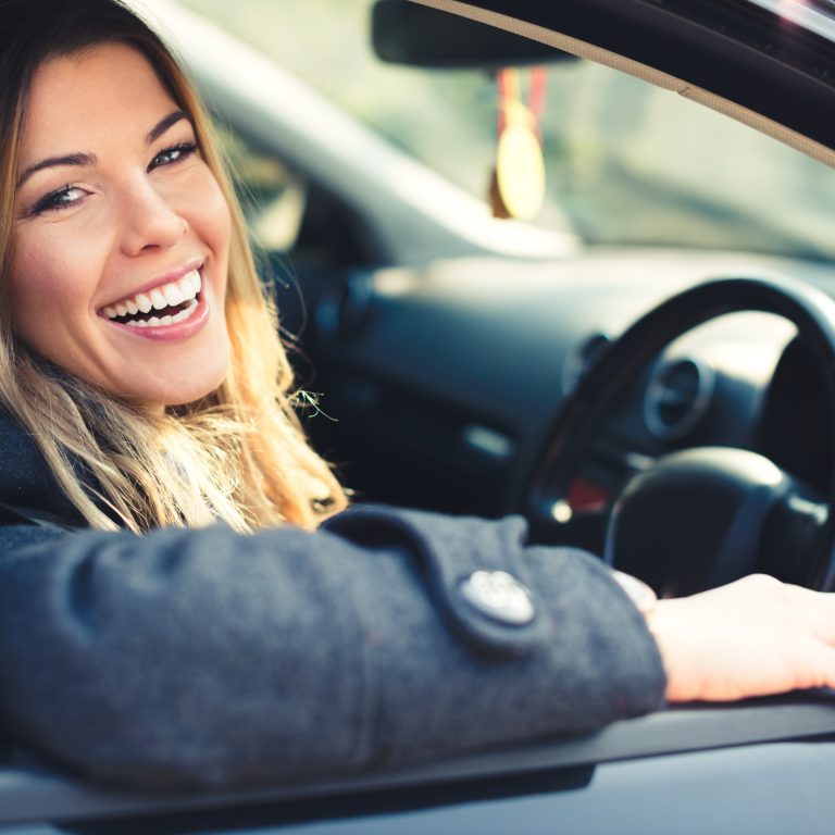 Happy Scullion LAW client sits in car smiling