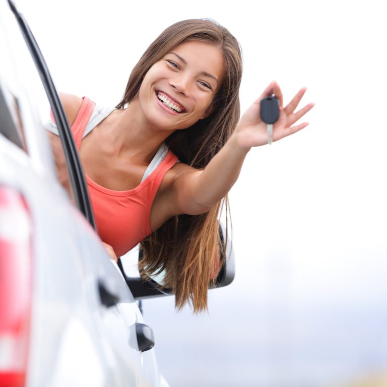 Happy Scullion law firm Female client leans outside vehicle showing off key