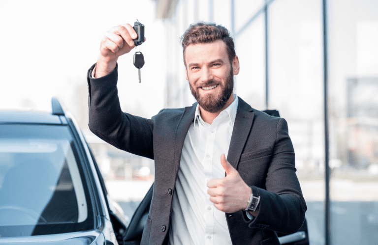 Happy Scullion LAW male client gives thumbs up holding car keys aloft
