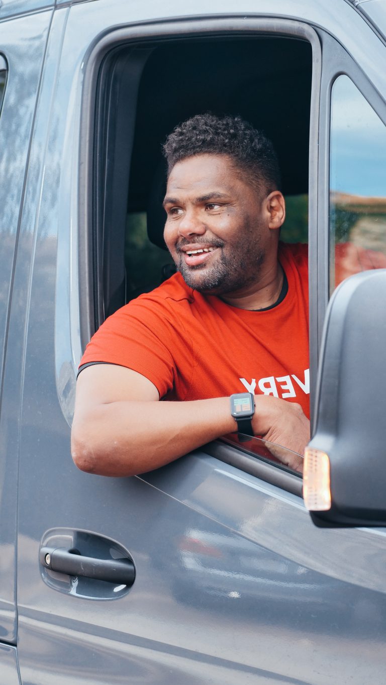 Happy Scullion LAW male client leans out his car window