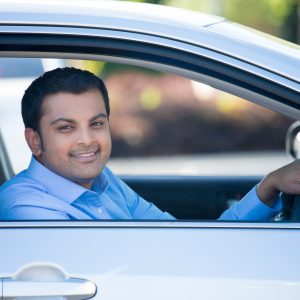 Man smiling sitting in car