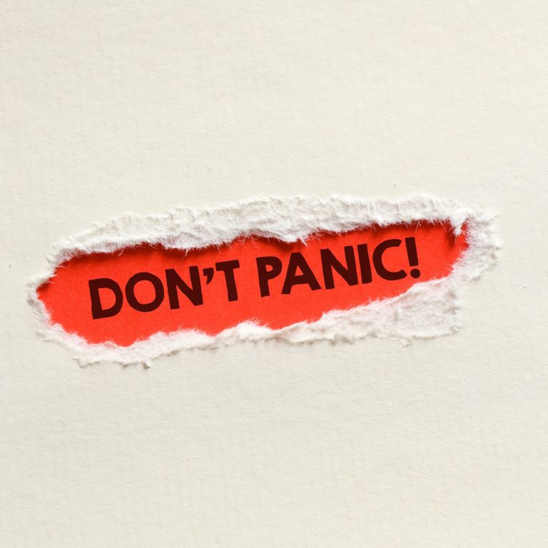 Paper torn out to reveal the words dont panic