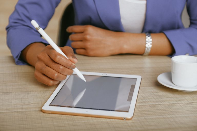 Scullion LAW solicitor reads document on a tablet using stylus pen