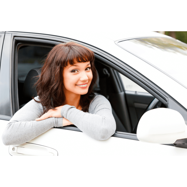 Woman smiles as she leans out of drivers side window