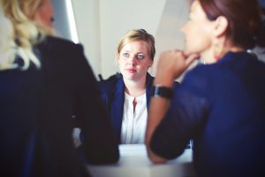 Three women at conference table discuss alternatives to divorce