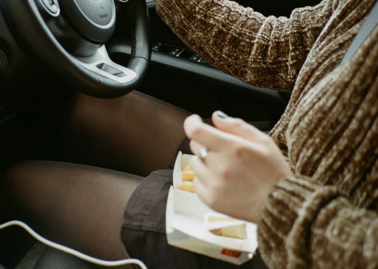 Girl eats whilst driving
