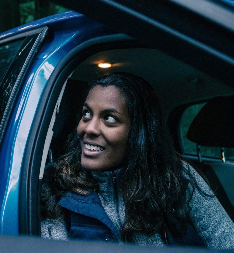 Female driver smiles at police requesting her insurance