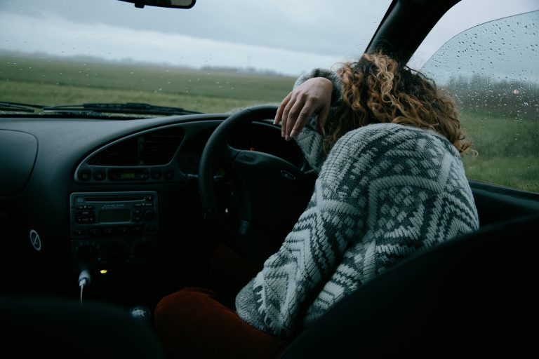 Woman sleeps behind the steering
