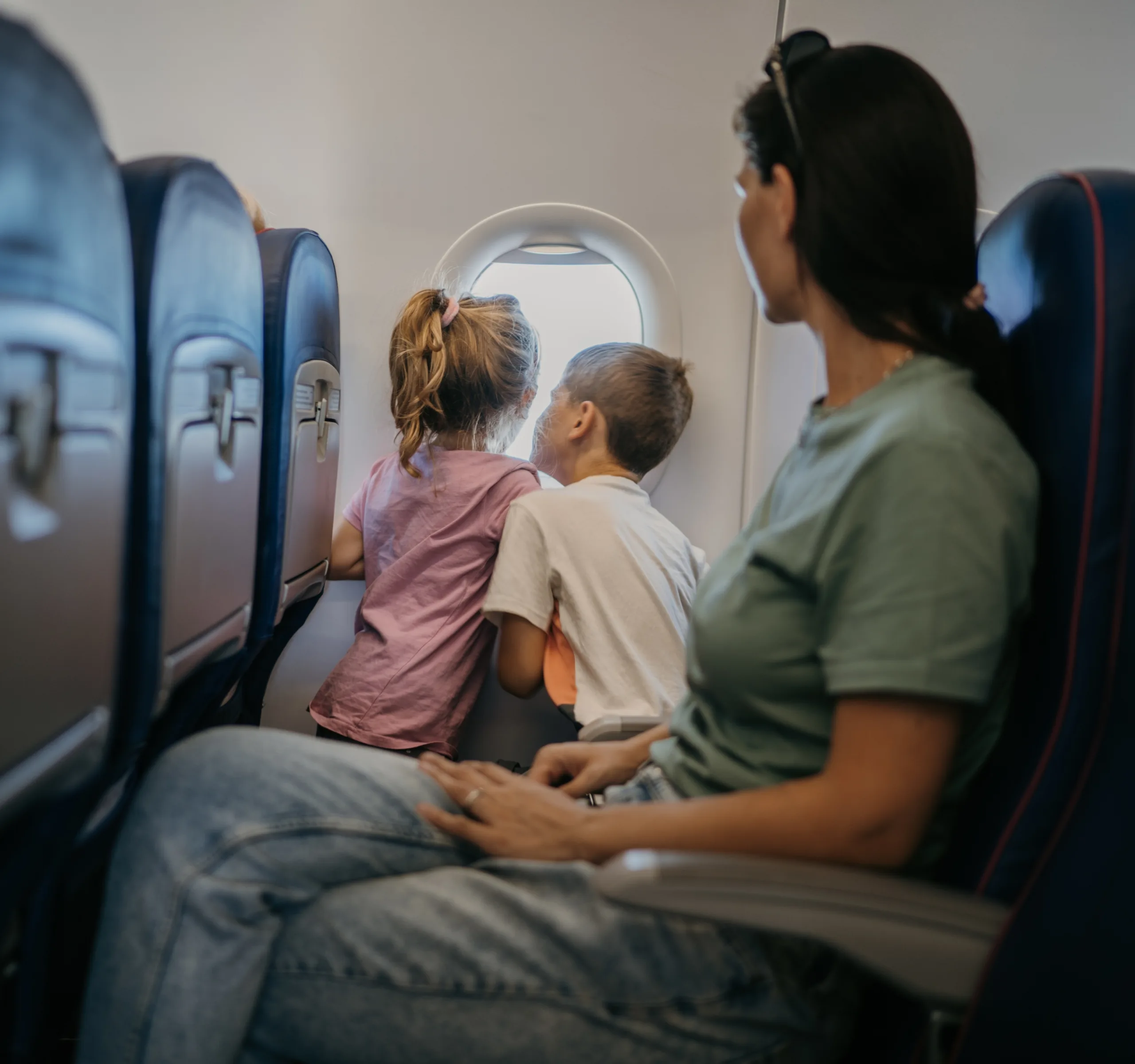Mother and two kids on a plane for relocation of children