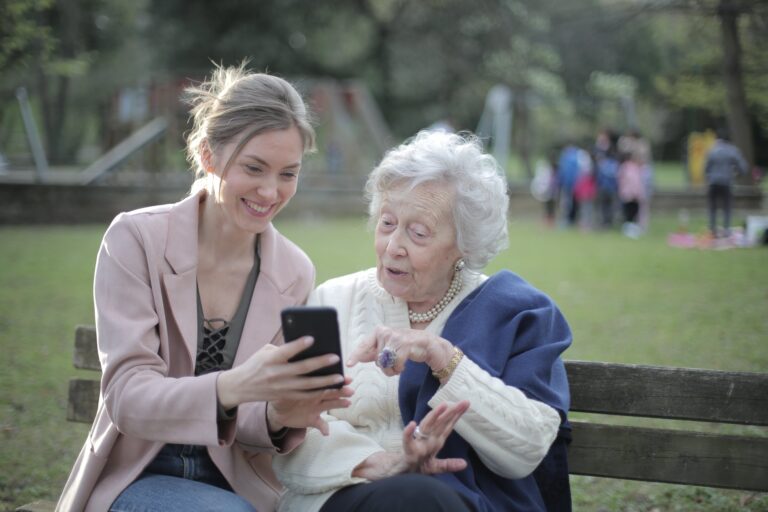 Woman shown her gran something on the phone in the park