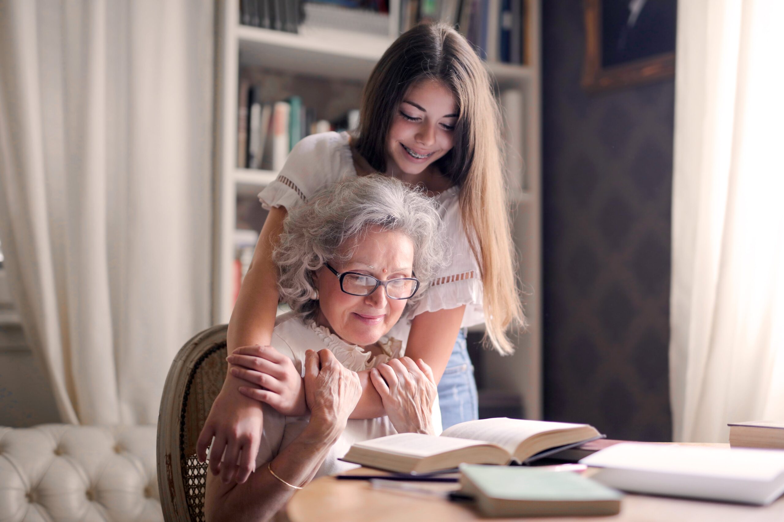 Grandmom Enjoys time reading with granddaughter embracing her