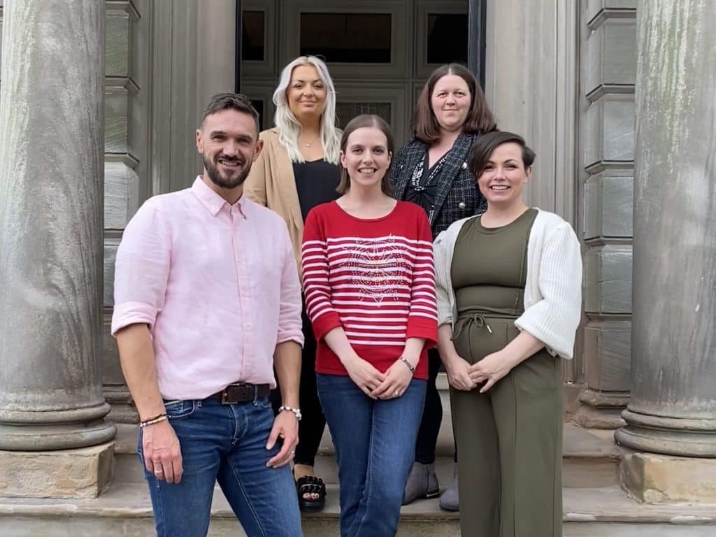 Wills, Powers of Attorney, and Bereavement team celebrating Ailidh Ballantyne's promotion to Head of Department, standing outside Scullion LAW's Hamilton office.