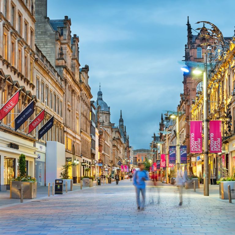 People walking down the street showing retail units and commercial property in Glasgow Scullion LAW