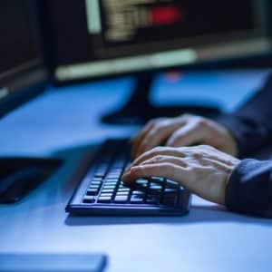 man typing on keyboard