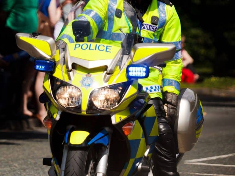Police officer on a motorbike conducting roadside drug driving checks. Scullion LAW offers legal assistance for drug driving charges.