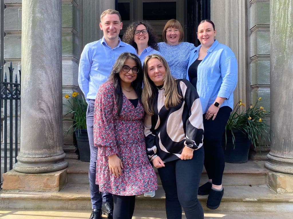 Scullion LAW's Property Law Team stand outside Hamilton Office to celebrate Associate Director Farrah Ali's 10-year milestone of dedicated service.