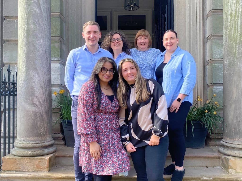 Scullion LAW's Property Law Team stand outside Hamilton Office to celebrate Associate Director Farrah Ali's 10-year milestone of dedicated service.