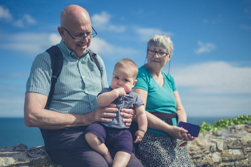 Smiling older couple with their grandchildren